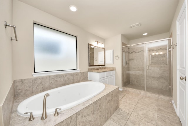 5627 Darling St, Houston, TX 77007 - full bathroom featuring vanity, a tub with jets, a stall shower, recessed lighting, and tile patterned flooring