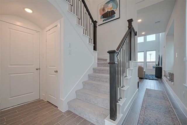 11251 Buchanan Coves Ln, Cypress, TX 77433 - stairs with wood finished floors, a high ceiling, and recessed lighting