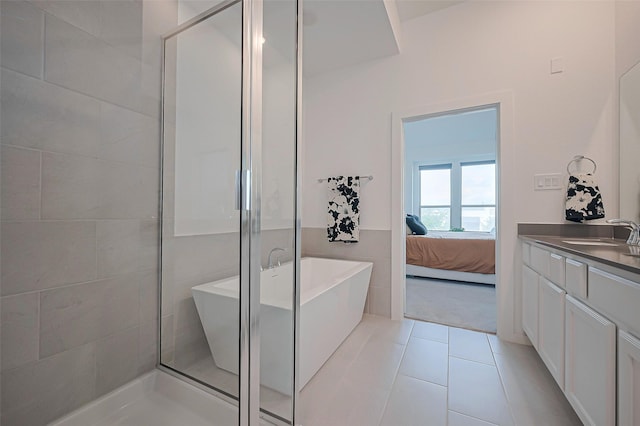 11251 Buchanan Coves Ln, Cypress, TX 77433 - bathroom with a soaking tub, a shower with door, vanity, ensuite bath, and tile patterned floors