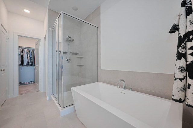 11251 Buchanan Coves Ln, Cypress, TX 77433 - full bath featuring a spacious closet, a soaking tub, a shower stall, and recessed lighting