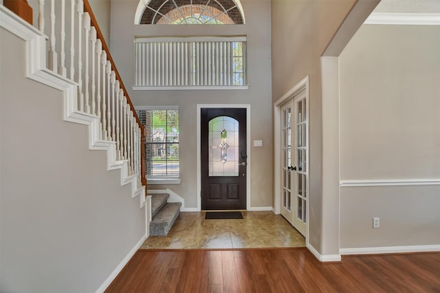 7818 Desert Canyon Ct, Houston, TX 77041 - entryway with wood finished floors, stairs, baseboards, a high ceiling, and french doors