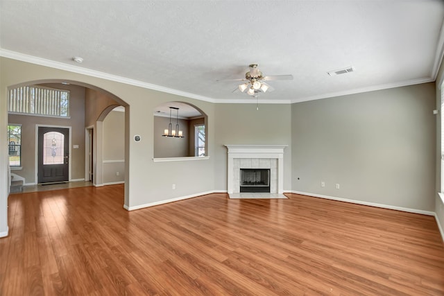 7818 Desert Canyon Ct, Houston, TX 77041 - unfurnished living room with ceiling fan, plenty of natural light, light wood-style flooring, a fireplace, and ornamental molding