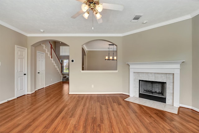 7818 Desert Canyon Ct, Houston, TX 77041 - unfurnished living room with a fireplace, wood finished floors, a ceiling fan, ornamental molding, and baseboards