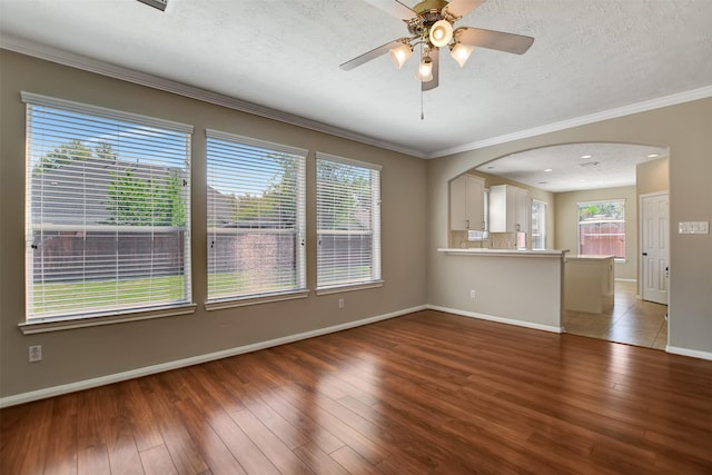 7818 Desert Canyon Ct, Houston, TX 77041 - unfurnished living room with ornamental molding, light wood finished floors, baseboards, arched walkways, and ceiling fan