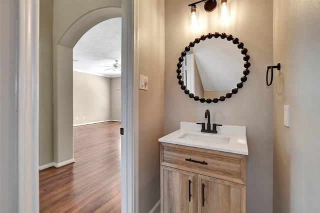7818 Desert Canyon Ct, Houston, TX 77041 - bathroom with vanity, wood finished floors, ceiling fan, and baseboards