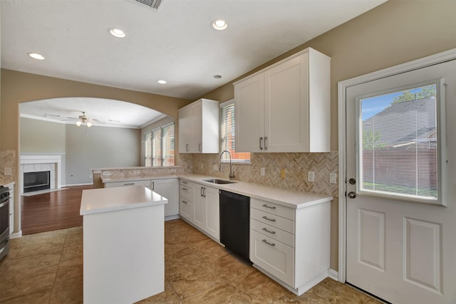 7818 Desert Canyon Ct, Houston, TX 77041 - kitchen with a sink, a ceiling fan, black dishwasher, tasteful backsplash, and light countertops