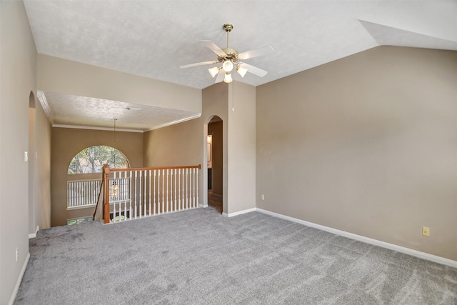 7818 Desert Canyon Ct, Houston, TX 77041 - unfurnished room featuring a ceiling fan, carpet flooring, arched walkways, baseboards, and vaulted ceiling