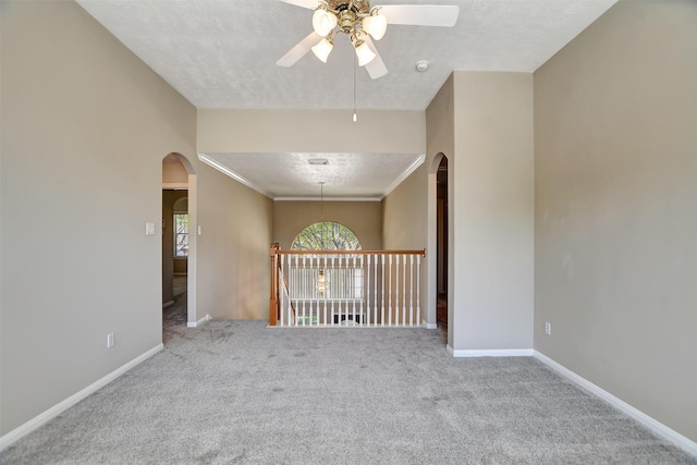 7818 Desert Canyon Ct, Houston, TX 77041 - empty room with arched walkways, ceiling fan, carpet, and a textured ceiling