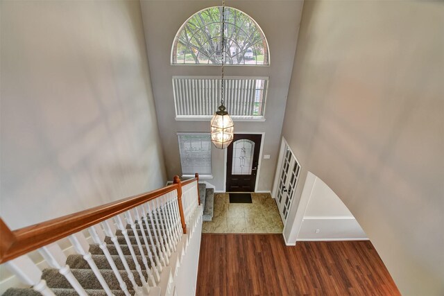 7818 Desert Canyon Ct, Houston, TX 77041 - entryway featuring wood finished floors, baseboards, a high ceiling, and stairs