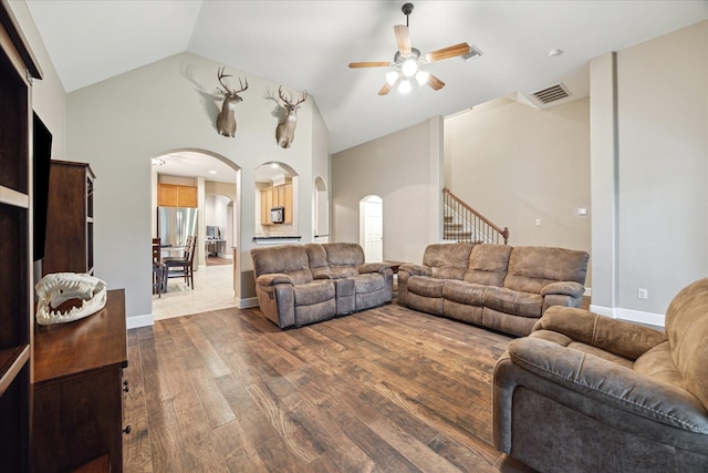 18411 S Raven Shore Dr, Cypress, TX 77433 - living area featuring arched walkways, ceiling fan, dark wood-type flooring, and high vaulted ceiling