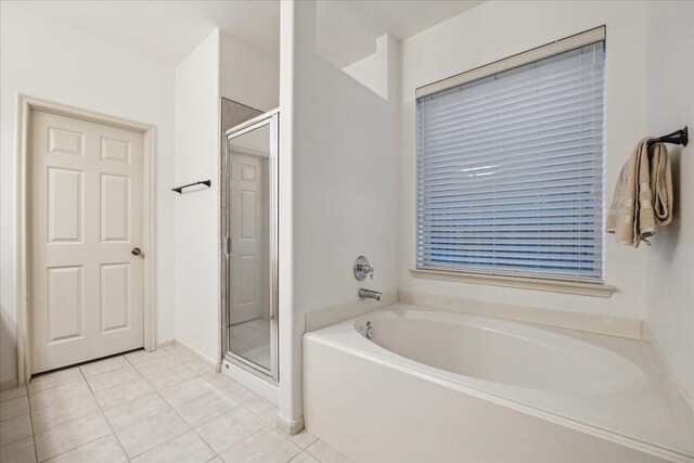 18411 S Raven Shore Dr, Cypress, TX 77433 - bathroom featuring a bath, a shower stall, and tile patterned floors