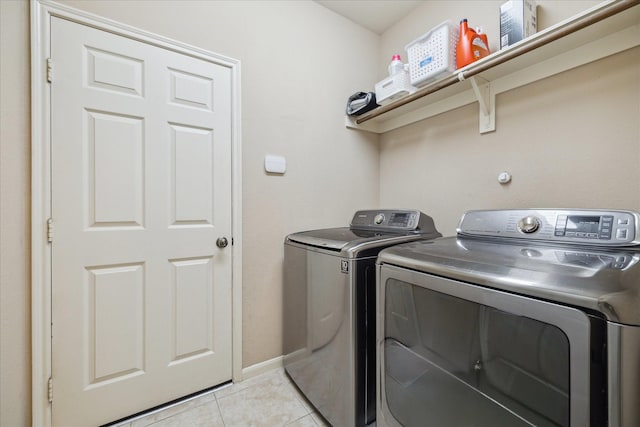 18411 S Raven Shore Dr, Cypress, TX 77433 - laundry area featuring washing machine and clothes dryer and light tile patterned floors