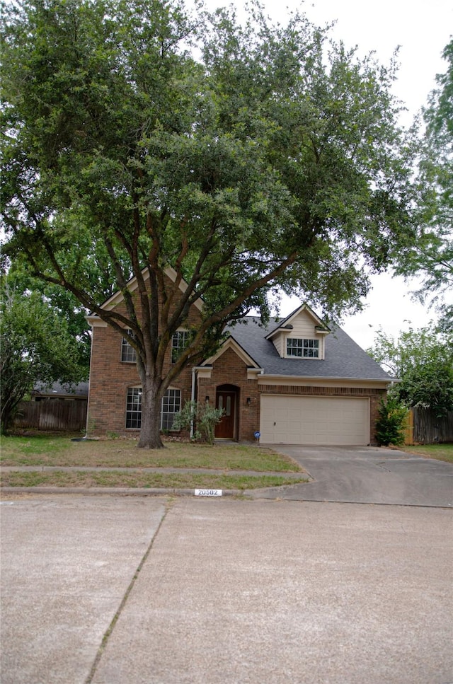 20502 Big Wells Dr, Katy, TX 77449 - traditional-style home featuring brick siding, driveway, and a garage