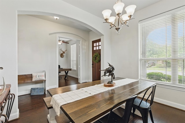 2114 Holly Manor Ct, Katy, TX 77493 - dining room featuring arched walkways, plenty of natural light, dark wood-style floors, and a chandelier