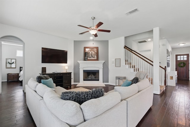 2114 Holly Manor Ct, Katy, TX 77493 - living room with ceiling fan, stairs, a fireplace with raised hearth, dark wood-type flooring, and recessed lighting