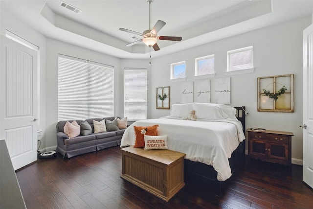 2114 Holly Manor Ct, Katy, TX 77493 - bedroom with a raised ceiling, dark wood-style flooring, and ceiling fan