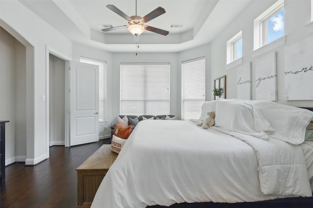 2114 Holly Manor Ct, Katy, TX 77493 - bedroom featuring a tray ceiling, dark wood-type flooring, baseboards, and a ceiling fan