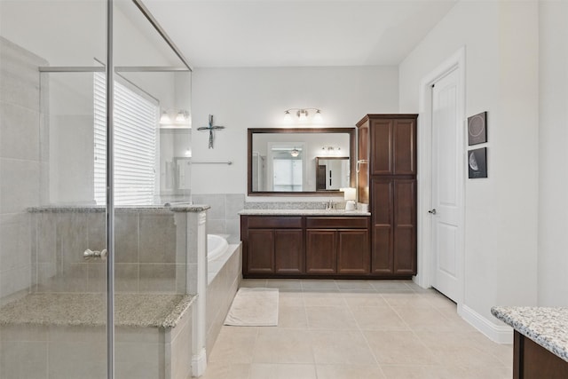 2114 Holly Manor Ct, Katy, TX 77493 - bathroom featuring vanity, a shower stall, a garden tub, tile patterned floors, and ceiling fan