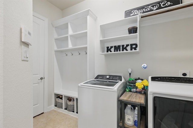 2114 Holly Manor Ct, Katy, TX 77493 - laundry area with washer and dryer and tile patterned flooring