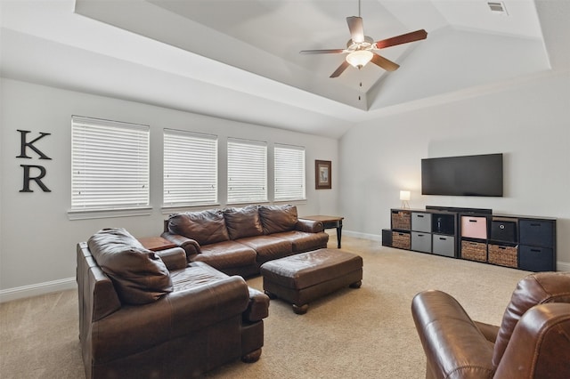 2114 Holly Manor Ct, Katy, TX 77493 - carpeted living area featuring ceiling fan, vaulted ceiling, a tray ceiling, and baseboards