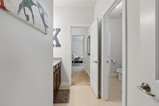 2114 Holly Manor Ct, Katy, TX 77493 - hallway featuring light tile patterned flooring and baseboards