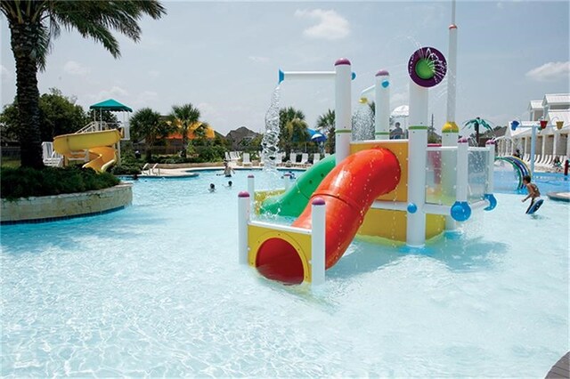 21123 Amber Crossing Dr, Richmond, TX 77406 - view of playground with a community pool and a water play area