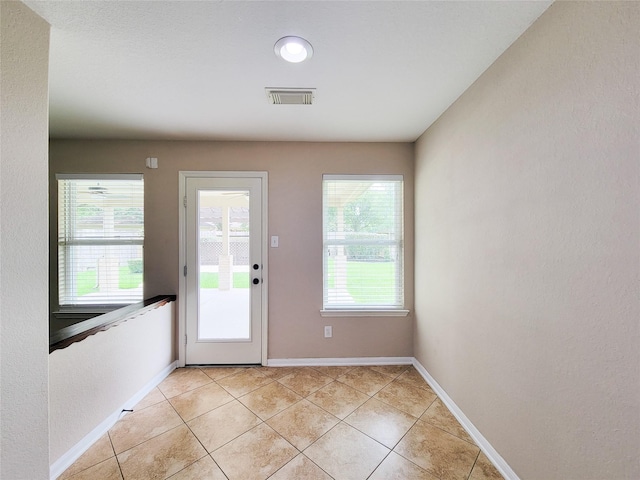 21123 Amber Crossing Dr, Richmond, TX 77406 - doorway to outside featuring light tile patterned floors and baseboards