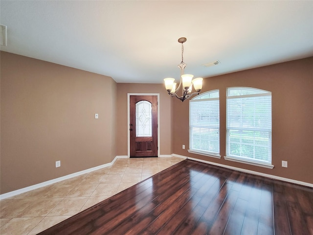 21123 Amber Crossing Dr, Richmond, TX 77406 - foyer with a chandelier, light wood-type flooring, and baseboards