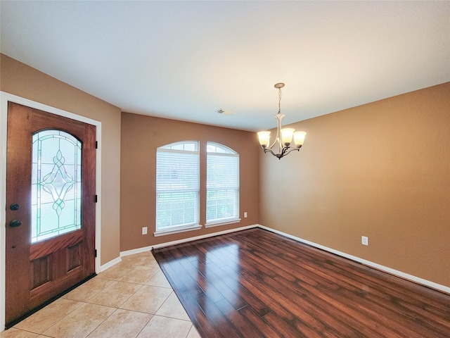 21123 Amber Crossing Dr, Richmond, TX 77406 - entryway with healthy amount of natural light, a chandelier, baseboards, and light wood-style floors