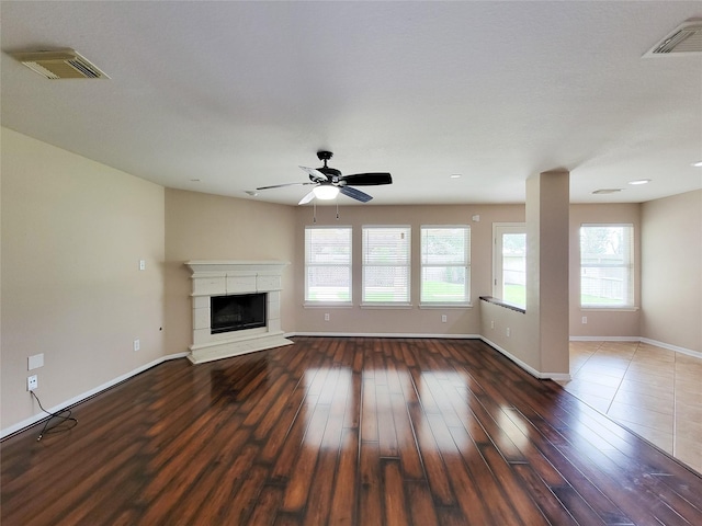 21123 Amber Crossing Dr, Richmond, TX 77406 - unfurnished living room with healthy amount of natural light, ceiling fan, wood finished floors, and baseboards