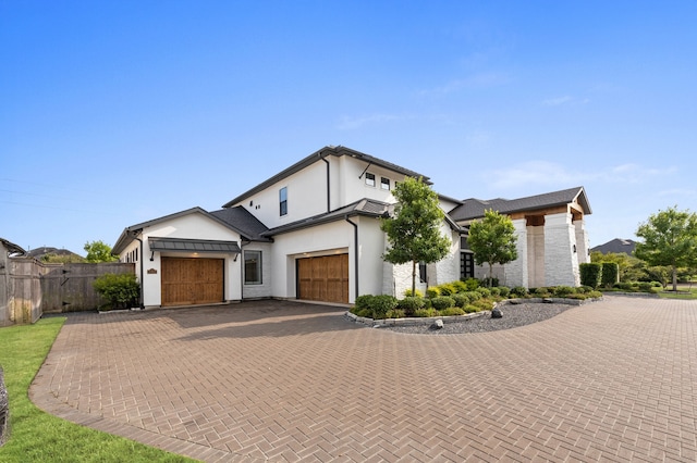 27927 Indigo Ridge Dr, Fulshear, TX 77441 - contemporary home featuring a garage, decorative driveway, and stucco siding
