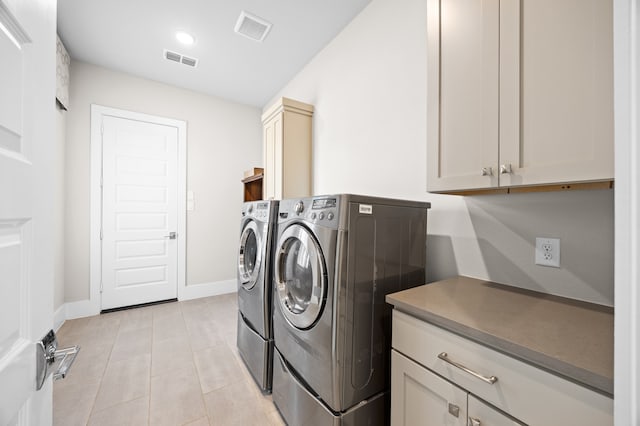 27927 Indigo Ridge Dr, Fulshear, TX 77441 - washroom featuring washer and clothes dryer, cabinet space, baseboards, and light tile patterned flooring