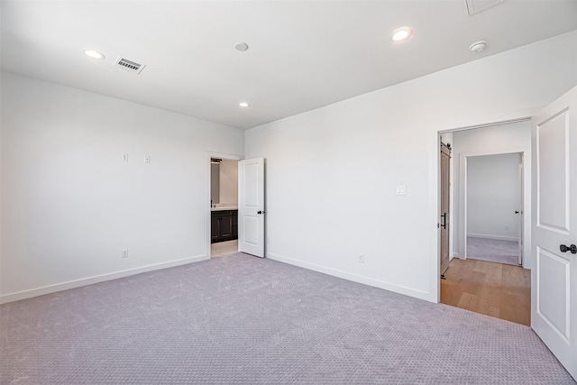 2320 Mills St, Houston, TX 77026 - empty room featuring light carpet, a smoke detector, baseboards, and recessed lighting