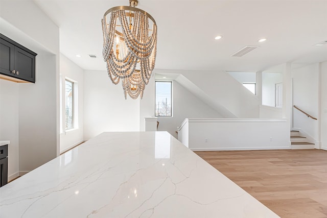 2320 Mills St, Houston, TX 77026 - unfurnished dining area featuring a chandelier, light wood-style floors, recessed lighting, and baseboards