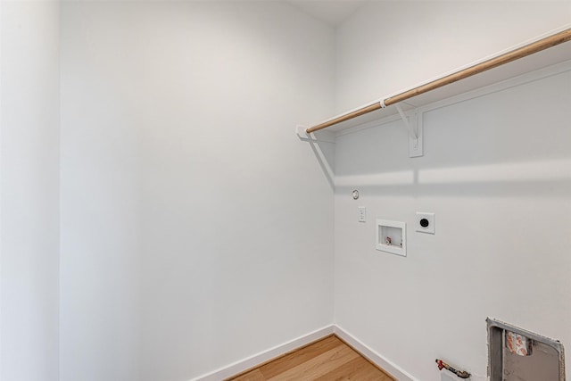 2320 Mills St, Houston, TX 77026 - washroom with light wood-type flooring, baseboards, washer hookup, electric dryer hookup, and hookup for a gas dryer