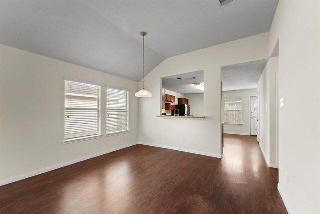 2611 Verano Dr, Richmond, TX 77406 - unfurnished dining area featuring dark wood-type flooring, vaulted ceiling, and baseboards