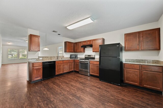 2611 Verano Dr, Richmond, TX 77406 - kitchen with black appliances, under cabinet range hood, dark wood finished floors, a sink, and brown cabinetry