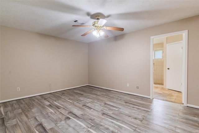 228 Hickory St, Huntsville, TX 77320 - spare room featuring wood finished floors, a ceiling fan, and baseboards