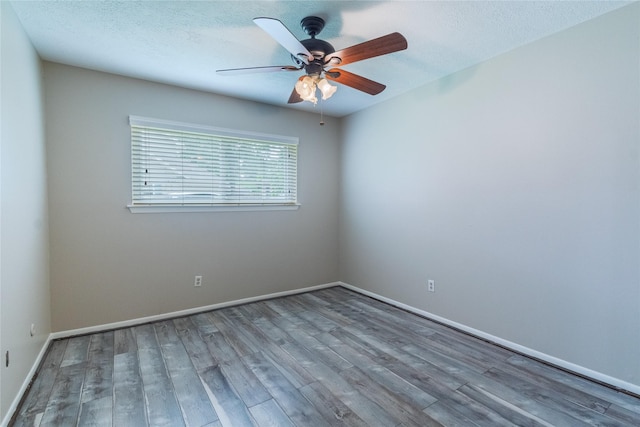 228 Hickory St, Huntsville, TX 77320 - unfurnished room featuring wood finished floors, ceiling fan, baseboards, and a textured ceiling