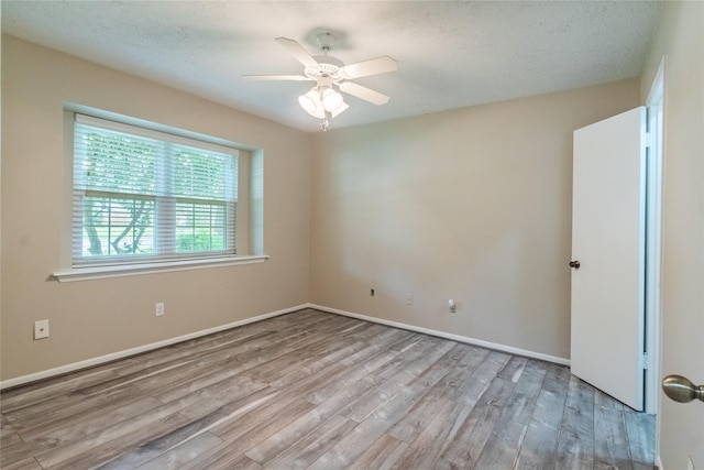 228 Hickory St, Huntsville, TX 77320 - unfurnished room with wood finished floors, a ceiling fan, and baseboards
