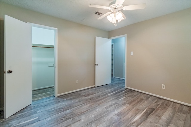 228 Hickory St, Huntsville, TX 77320 - unfurnished bedroom featuring wood finished floors, baseboards, a closet, and ceiling fan