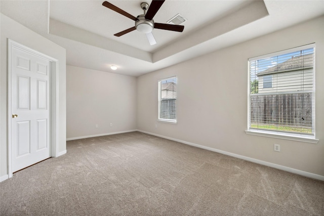12311 Carriage Oak Cir, Humble, TX 77346 - unfurnished bedroom featuring carpet, a raised ceiling, multiple windows, and baseboards