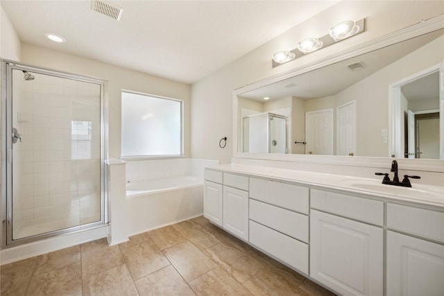 12311 Carriage Oak Cir, Humble, TX 77346 - bathroom with double vanity, a shower stall, a bath, and recessed lighting