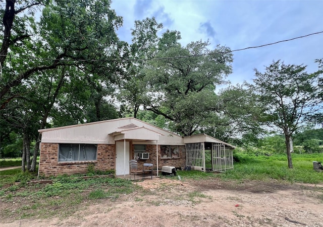 22606 Fm 359th Rd, Hempstead, TX 77445 - view of front facade featuring brick siding and view of scattered trees