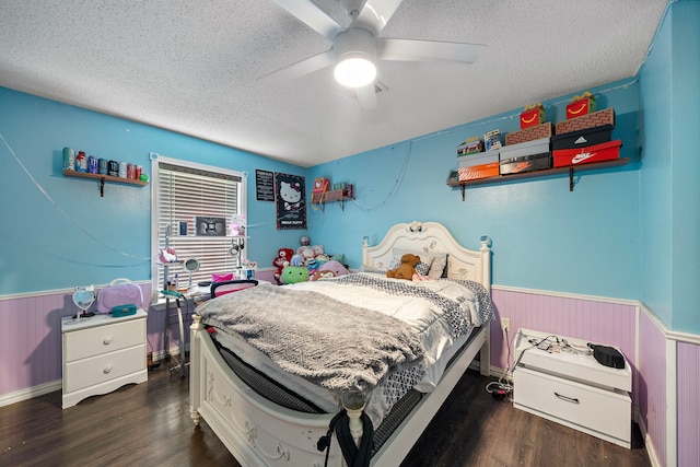 22307 Saddlewood Dr, Katy, TX 77449 - bedroom featuring a wainscoted wall, a textured ceiling, dark wood-style floors, and a ceiling fan