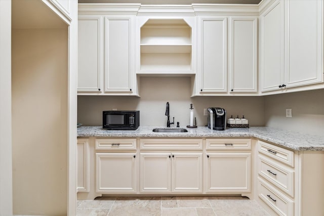 27521 Velvet Sky Way, Spring, TX 77386 - kitchen with a sink, black microwave, open shelves, and light stone countertops