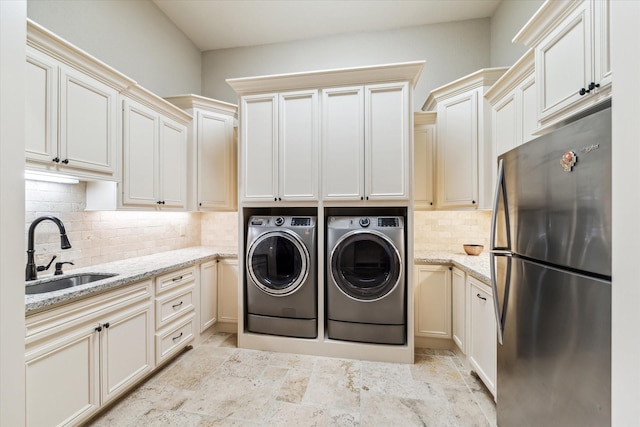 27521 Velvet Sky Way, Spring, TX 77386 - washroom with separate washer and dryer and light stone finish flooring