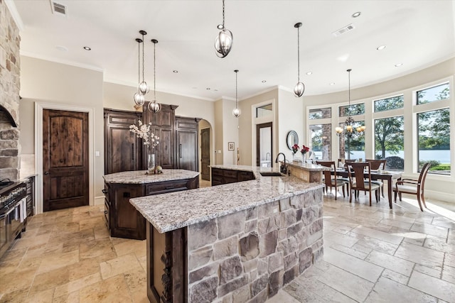 27521 Velvet Sky Way, Spring, TX 77386 - kitchen with a large island, stone tile floors, recessed lighting, a sink, and dark brown cabinetry
