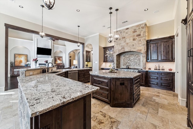 27521 Velvet Sky Way, Spring, TX 77386 - kitchen with a large island, arched walkways, ornamental molding, a ceiling fan, and stone tile floors
