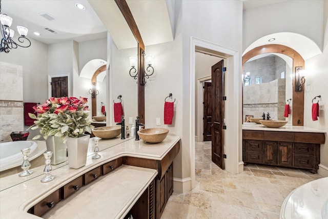 27521 Velvet Sky Way, Spring, TX 77386 - full bathroom with vanity, a bathtub, stone tile flooring, a chandelier, and baseboards